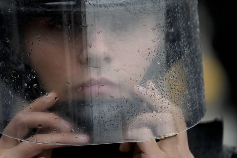 Un agente de policía se ajusta el casco en un aparte de una manifestación antigubernamental contra la escasez de comida en comedores benéficos y las reformas económicas propuestas por el presidente, Javier Milei, en Buenos Aires, Argentina, el 7 de mayo de 2024. (AP Foto/Natacha Pisarenko)