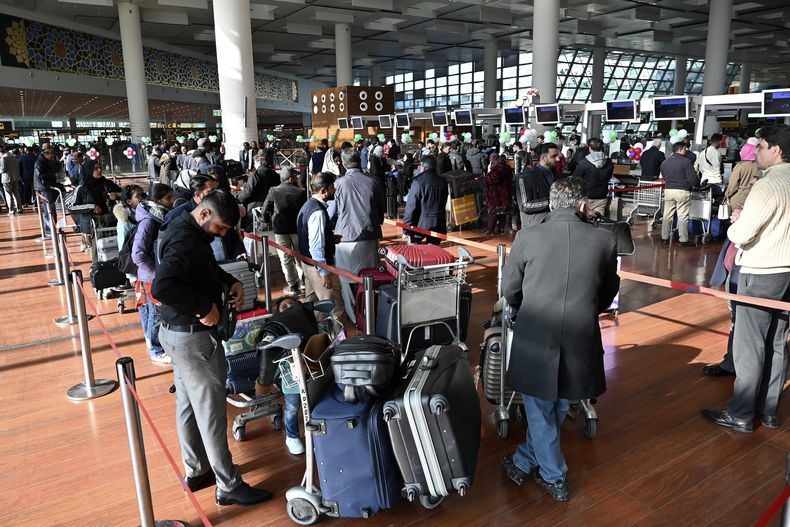 Pasajeros esperan abordar un vuelo de Pakistan International Airlines (PIA) a París luego que la aerolínea estatal reanudó los vuelos directos a Europa luego que la UE levantó una prohibición de cuatro años, en el Aeropuerto Internacional de Islamabad, Pakistán, el viernes 10 de enero de 2025. (AP Foto)