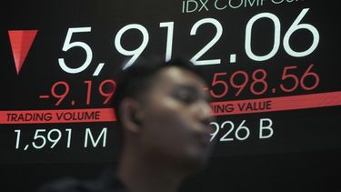 Un hombre frente a una pizarra electrónica que muestra los precios de las acciones en la Bolsa de Valores de Indonesia, en Yakarta, Indonesia, el martes 8 de abril de 2025. (AP Foto/Achmad Ibrahim)