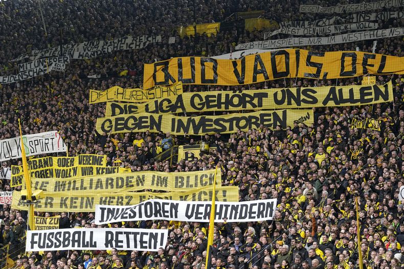 ARCHIVOS - Hinchas sostienen cartelas en contra de la participación de inversionistas en el fútbol alemán durante el partido entre Borussia Dortmund y Unión Berlín, el sábado 8 de abril de 2023, en Dortmund. (AP Foto/Martin Meissner)