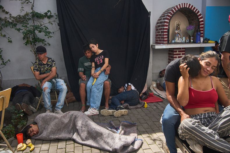 Personas se relajan después de almorzar en un centro Hogares de Cristo en el barrio Carlos Mugica, que forma parte de una red de centros comunitarios que fue apoyada inicialmente por el difunto papa Francisco, en Buenos Aires, Argentina, el jueves 19 de marzo de 2026. (AP Foto/Rodrigo Abd)