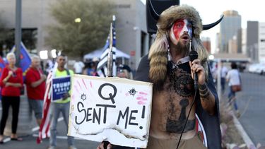 ARCHIVO - Jacob Anthony Chansley, que también se hace llamar Jake Angeli, creyente de Qanon, habla ante una multitud de partidarios del presidente Donald Trump fuera de la Oficina del Registrador del Condado de Maricopa, donde se cuentan los votos de la elección general, en Phoenix, Arizona, el 5 de noviembre de 2020. (AP Foto/Dario Lopez-Mills, Archivo)