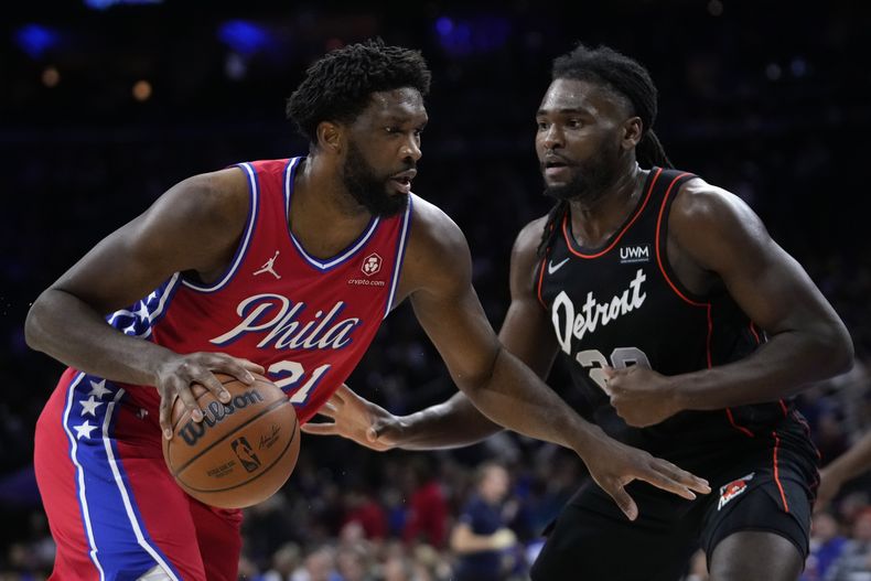 Joel Embiid (izquierda) de los 76ers de Filadelfia intenta rebasar a Isaiah Stewart de los Pistons de Detroit durante la primera mitad del juego de la NBA, el viernes 15 de diciembre de 2023, en Filadelfia. (AP Foto/Matt Slocum)