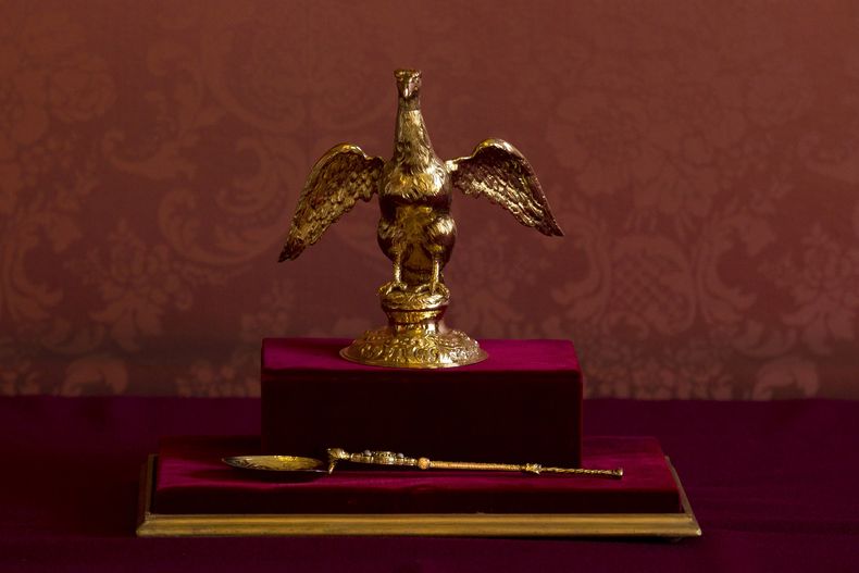 ARCHIVO- La Ampolla y la Cuchara de Coronación utilizadas en la coronación de la Reina Isabel II de Gran Bretaña en 1953 se muestran durante una recepción de múltiples religiones para conmemorar el Jubileo de Diamante de la ascención de la reina en el Palacio de Lambeth en Londres, el miércoles 15 de febrero de 2012. La cuchara es fundamental para la parte más sagrada de la ceremonia de coronación, cuando el arzobispo de Canterbury vertirá aceite sagrado de la ampolla o matraz en forma de águila en la cuchara y luego la frote en las manos, el pecho y la cabeza del rey durante la coronación del rey Carlos III el sábado 6 de mayo de 2023. (Foto AP/Matt Dunham, Pool, archivo)