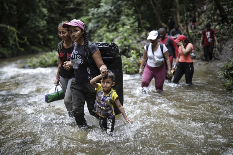 Migrantes cruzan un río en la selva del Darién el miércoles 10 de mayo de 2023, en un recorrido desde Colombia a Panamá, con la esperanza de llegar a Estados Unidos. (AP Foto/Iván Valencia)
