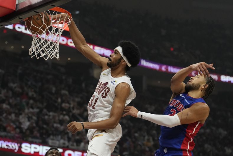Jarrett Allen (31), de los Cavaliers de Cleveland, retaca el balón frente a Cade Cunningham (2), de los Pistons de Detroit, en la primera mitad del juego de baloncesto de la NBA, el viernes 25 de octubre de 2024, en Cleveland. (AP Foto/Sue Ogrocki)