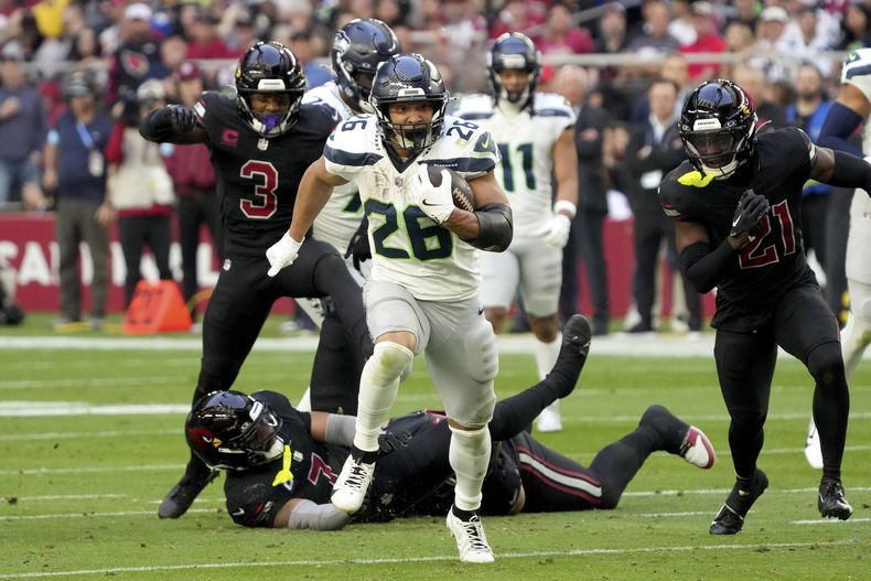 El running back Zach Charbonnet (26), de los Seahawks de Seattle, corre para un touchdown en contra de los Cardinals de Arizona durante la primera mitad del juego de la NFL del domingo 8 de diciembre de 2024, en Glendale, Arizona. (AP Foto/Rick Scuteri)