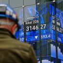 Una persona se encuentra frente a una pantalla electrónica que muestra el índice Nikkei de Japón en una correduría de valores el jueves 2 de abril de 2026, en Tokio. (AP Foto/Eugene Hoshiko)