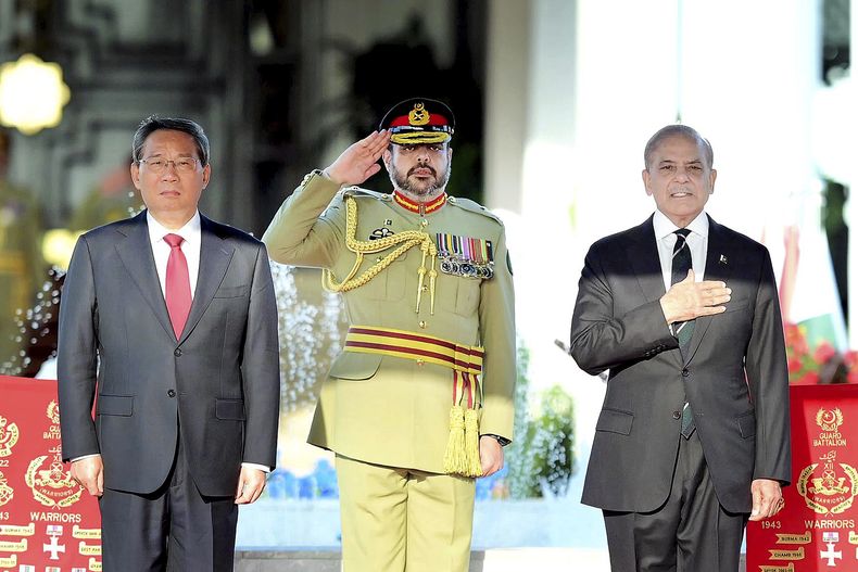 En esta foto publicada por el Departamento de Información de Prensa, el premier chino, Li Qiang, a la izquierda, y el primer ministro de Pakistán, Shehbaz Sharif, asisten a una ceremonia de bienvenida en Islamabad, Pakistán, el lunes 14 de octubre de 2024. (Departamento de Información de Prensa, via AP)