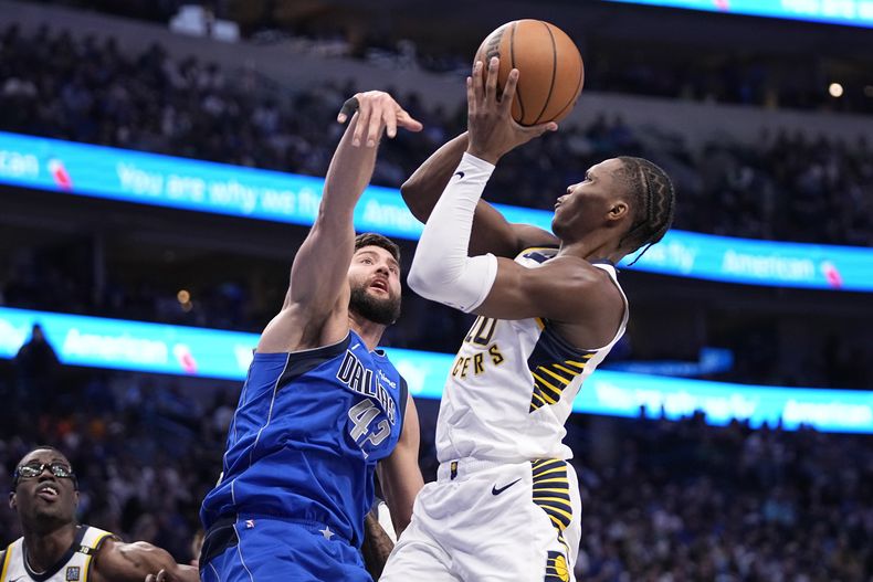 El base de los Pacers de Indiana Bennedict Mathurin lanza el balón frente a Max Kleber de los Mavericks de Dallas en el encuentro de la NBA del martes 5 de marzo del 2024. (AP Foto/Tony Gutierrez)