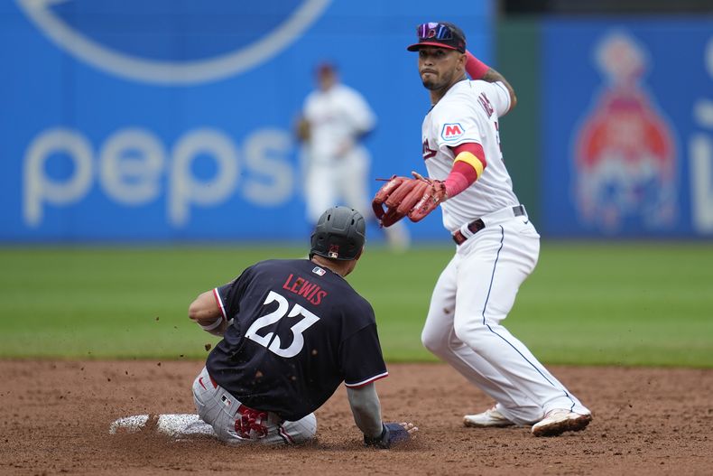 Gabriel Arias, derecha, de los Guardianes de Cleveland, retira a Royce Lewis (23), de los Mellizos de Minnesota, en segunda base después de una rola de Max Kepler, quien llegó a salvo a primera, en la sexta entrada del juego de béisbol del miércoles 6 de septiembre de 2023, en Cleveland. (AP Foto/Sue Ogrocki)