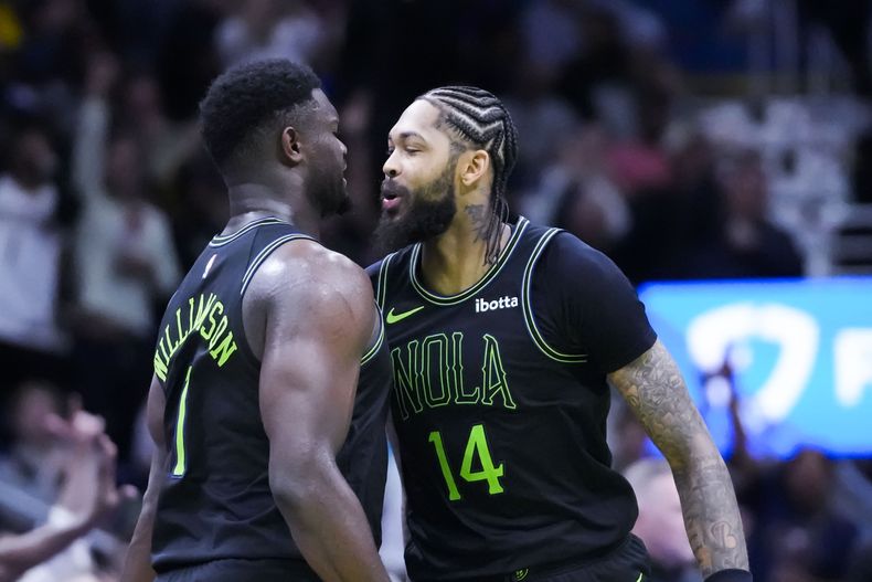 Brandon Ingram (14) y Zion Williamson (1), de los Pelicans de Nueva Orleáns, festejan un enceste en el partido del viernes 17 de noviembre de 2023, ante los Nuggets de Denver (AP Foto/Gerald Herbert)
