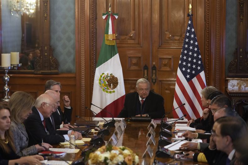 El presidente mexicano, Andrés Manuel López Obrador, en el centro, en un encuentro con el secretario de Estado estadounidense, Antony Blinken, arriba a la izquierda, parcialmente tapado, y la secretaria de Relaciones Exteriores mexicana, Alicia Bárcena, arriba a la derecha, en el Palacio Nacional, la oficina y residencia del presidente, en Ciudad de México, el miércoles 27 de diciembre de 2023. (AP Foto/Fernando Llano)