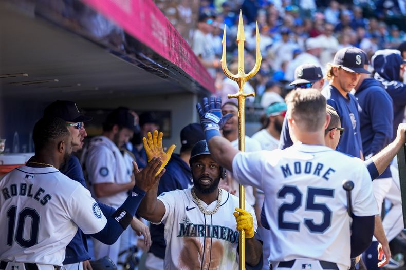 Randy Arozarena, de los Marineros de Seattle, sostiene un tridente en el dugout para celebrar su jonrón contra los Rays de Tampa Bay durante la octava entrada el miércoles 28 de agosto de 2024, en Seattle. (AP Foto/Lindsey Wasson)