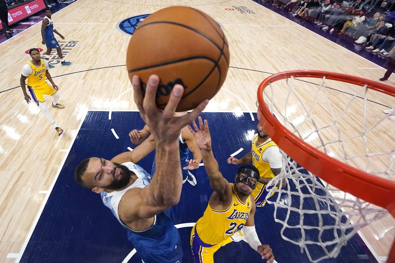 El francés Rudy Gobert, pívot de los Lakers de Los Ángeles, dispara frente a Rui Hachimura, de los Lakers de Los Ángeles, en el duelo del jueves 21 de diciembre de 2023 (AP Foto/Abbie Parr)