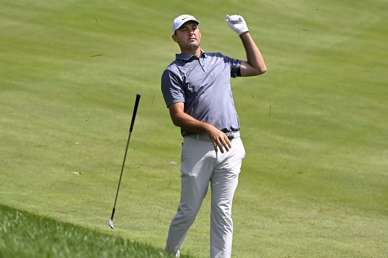 Scottie Scheffler suelta el bastón después de realizar su segundo golpe desde el rough en el primer hoyo de la segunda ronda del torneo de golf Travelers Championship en el campo TPC River Highlands, el viernes 20 de junio de 2025, en Cromwell, Connecticut. (AP Foto/Jessica Hill)