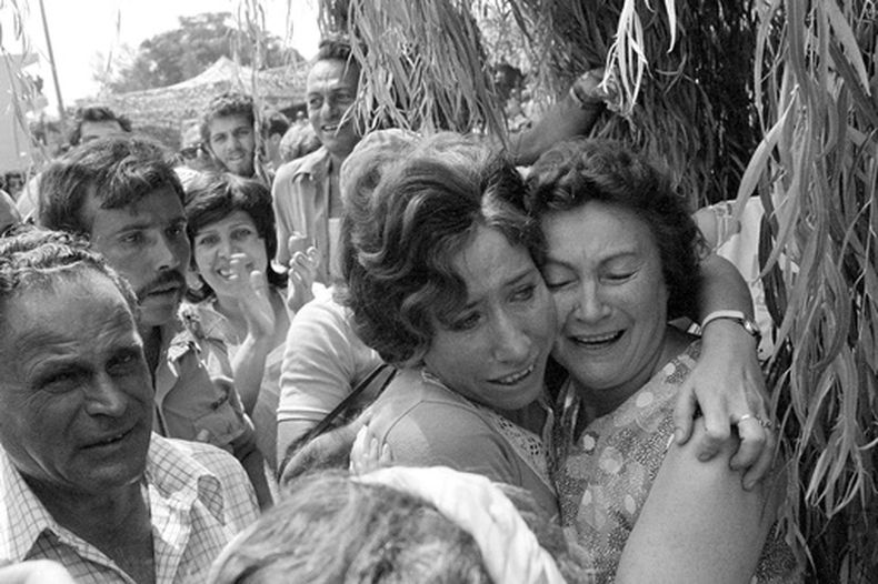 ARCHIVO – Una madre y su hija se abrazan tras la llegada de la segunda al aeropuerto Ben Gurion de Tel Aviv después de que tropas de paracaidistas israelíes la liberaran a ella y a otros rehenes que iban a bordo de un avión de Air France en el aeropuerto de Entebbe, en Uganda, el 4 de julio de 1976. (AP Foto/Nash, Archivo)