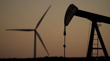 Un extractor de petróleo y un molino de energía eólica cerca de Hays, Kansas, el 30 de septiembre del 2024. (AP foto/Charlie Riedel)