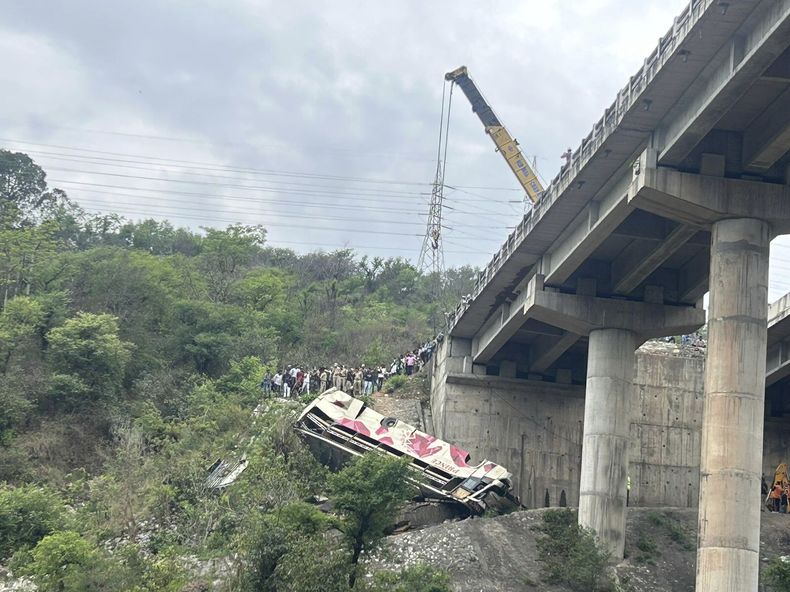 Rescatistas se preparan para utilizar una grúa con la que levantar un bus que llevaba a peregrinos hindúes a un santuario cuando se precipitó a un desfiladero, cerca de Jammu, India, el 30 de mayo de 2023. (AP Foto/Channi Anand)