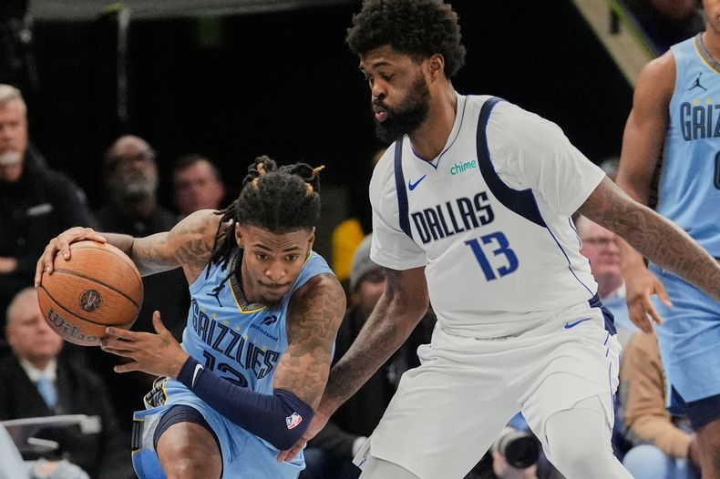 Ja Morant, de los Grizzlies de Memphis, elude a Naji Marshall, de los Mavericks de Dallas en el partido del viernes 7 de noviembre de 2025 (AP Foto/George Walker IV)