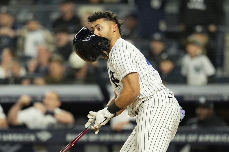 El dominicano Jasson Domínguez, de los Yankees de Nueva York, pierde el casco al conectar un doble de tres carreras ante los Reales de Kansas City, el martes 15 de abril de 2025 (AP Foto/Seth Wenig)
