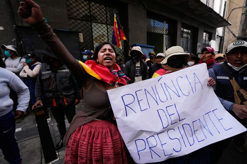 Una manifestante contraria al gobierno sostiene un cartel con la frase Renuncia del presidente, en La Paz, Bolivia, el 18 de mayo de 2026. (AP Foto/Juan Karita)