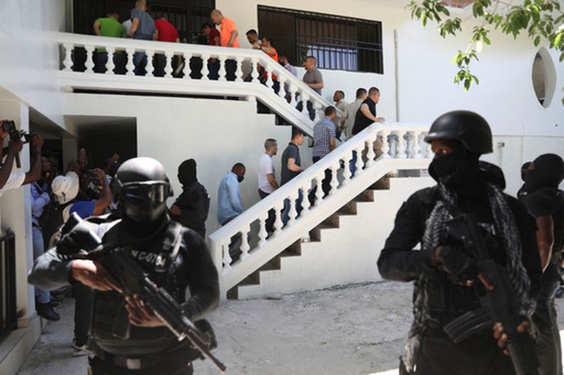 ARCHIVO - Colombianos y haitianos implicados en el asesinato en 2021 del presidente haitiano Jovenel Moisés son escoltados esposados a su audiencia judicial en Puerto Príncipe, Haití, el 26 de mayo de 2025. (Foto AP/Odelyn Joseph, Archivo)