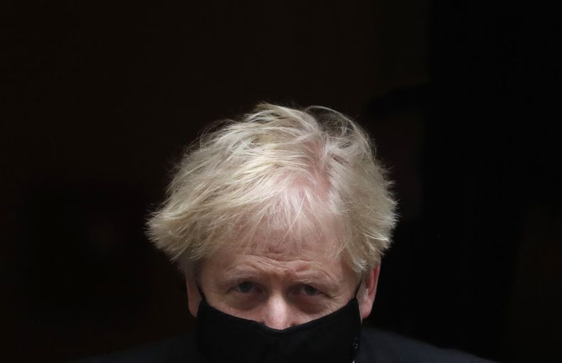 En esta imagen de archivo, el entonces primer ministro de Gran Bretaña, Boris Johnson, abandona su residencia oficial, en el número 10 de Downing Street, para asistir a una sesión de control semanal en el parlamento, en Londres, el 9 de diciembre de 2020. (AP Foto/Frank Augstein, archivo)