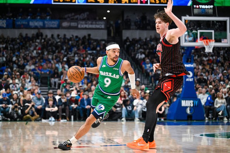 Ryan Nembhard, de los Mavericks de Dallas, lleva el balón frente a Lachlan Olbrich, de los Bulls de Chicago, durante el juego de baloncesto de la NBA del domingo 12 de abril de 2026, en Dallas. (AP Foto/Albert Pena)