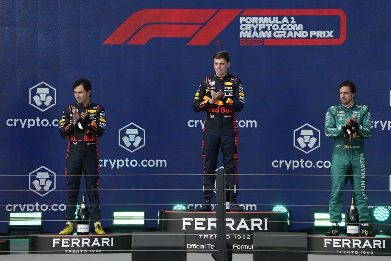 El podio del Gran Premio de Miami, con el ganador Max Verstappen (centro), el segundo Sergio Pérez (izquierda) y el tercero Fernando Alonso, el domingo 7 de mayo de 2023, en Miami Gardens. (AP Foto/Wilfredo Lee)