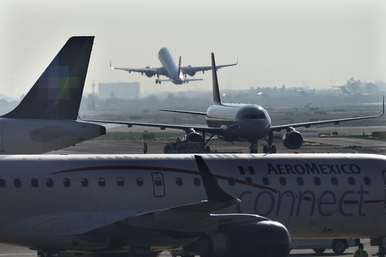 ARCHIVO - Un avión de pasajeros despega del Aeropuerto Internacional Benito Juárez el 12 de mayo de 2022 en la Ciudad de México, mientras otros aviones se desplazan en la pista. (AP Foto/Marco Ugarte, archivo)