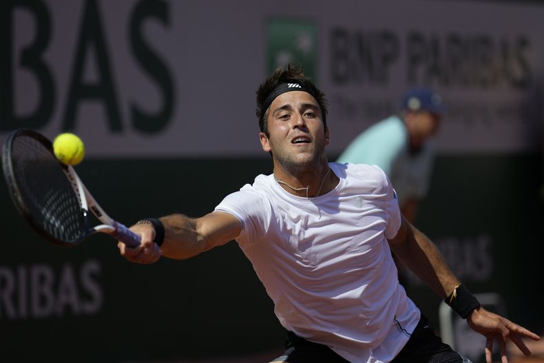 Tomás Etcheverry devuelve ante Alex De Miñaur durante la segunda ronda del Abierto de Francia, el jueves 1 de junio de 2023. (AP Foto/Thibault Camus)