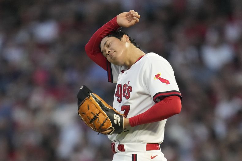 Shohei Ohtani (17), abridor de los Angelinos de Los Ángeles, se limpia el sudor sobre el montículo, durante la quinta entrada del juego de béisbol en contra de los Piratas de Pittsburgh, en Anaheim, California, el viernes 21 de julio de 2023. (AP Foto/Ashley Landis)