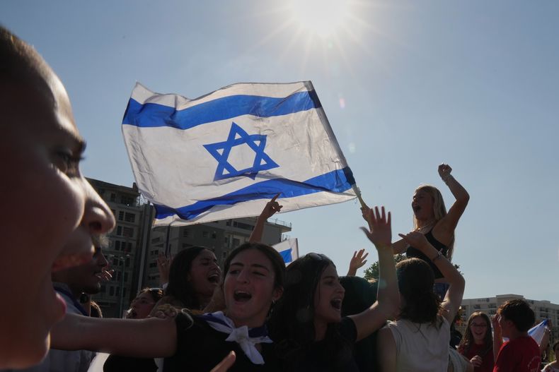 Una multitud festeja tras la llegada de los rehenes al Hospital Beilinson luego de su liberación del cautiverio en que los tenía Hamás en la Franja de Gaza, el lunes 13 de octubre de 2025, en Petah Tikva, Israel. (AP Foto/Francisco Seco)