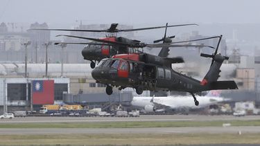 FILE - Two Sikorsky UH-60 Black Hawk helicopters approach during the annual Han Kuang military exercises that simulates an attack on an airfield at Taoyuan International Airport in Taoyuan, northern Taiwan, Wednesday, July 26, 2023. (AP Photo/ Chiang Ying-ying)