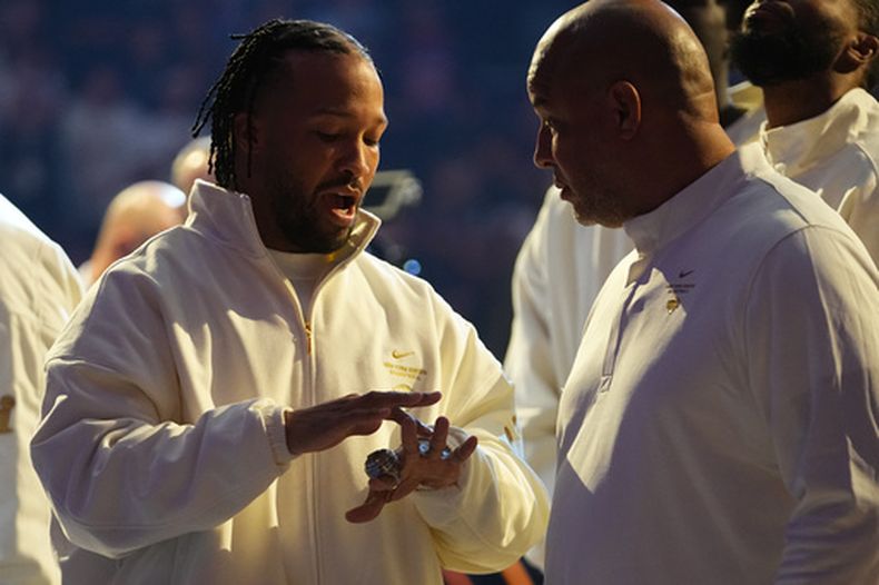 El base de los Knicks de Nueva York Jalen Brunson muestra el anillo de campeón a su padre Rick Brunson antes del encuentro ante los 76ers de Filadelfia el martes 20 de octubre del 2026. (AP Foto/Frank Franklin II)