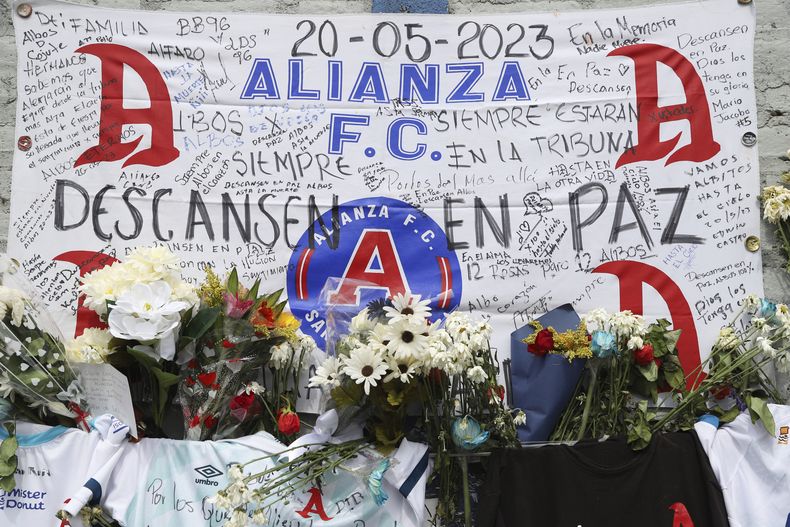 En la foto del lunes 22 de mayo de 2023 se aprecia un altar erigido por los aficionados al fútbol que perecieron en el Estadio Cuscatlán de San Salvador. La Fiscalía presentó acusación formal el miércoles 5 de mayo de 2023 contra el presidente del club Alianza y otros directivos del equipo de fútbol por la estampida que dejó nueve muertos. (AP Foto/Salvador Meléndez)