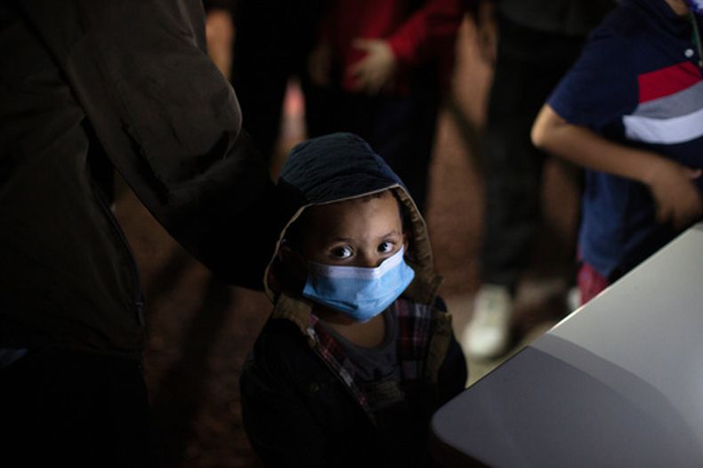 Un niño espera a responder preguntas de un agente de la Patrulla Fronteriza de Estados Unidos en un centro de acogida después de cruzar el río Bravo (Grande) en una balsa inflable, el 24 de marzo de 2021, en Roma, Texas. (AP Foto/Dario Lopez-Mills, Archivo)