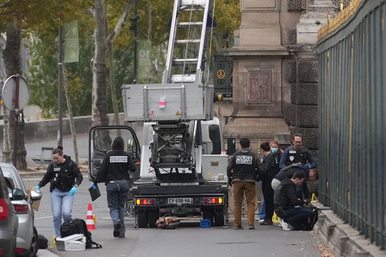 Agentes de policía buscan pistas junto a un elevador de cesta utilizado por ladrones el domingo 19 de octubre de 2025 en el museo del Louvre en París. (Foto AP/Thibault Camus)