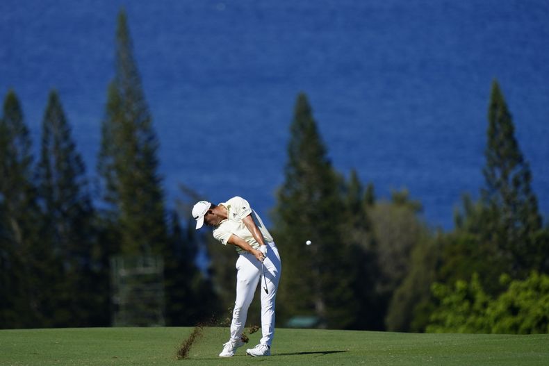 ARCHIVO - Collin Morikawa golpea desde el fairway en el hoyo cuatro durante la primera ronda del Torneo de Campeones, el 6 de enero de 2022, en el Kapalua Plantation Course en Kapalua, Hawai. Morikawa está entre los jugadores que ayudan a contribuir para campaas de caridad locales en apoyo a las familias que perdieron sus hogares por los incendios en Lahaina. (AP Foto/Matt York, Archivo)