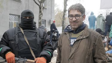 americateve | En imagen tomada el 13 de abril de 2014 el periodista Simon Ostrovsky (derecha) posa junto a un hombre armado simpatizante de Rusia en una estaci&oacute;n de polic&iacute;a ocuopada por los insurgentes. Ostrovsky, periodista que trabaja para Vice News, no