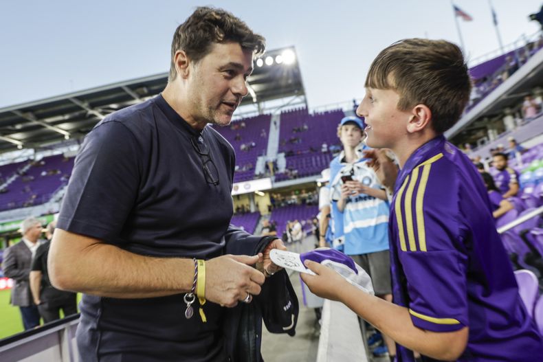 El técnico argentino de Estados Unidos, Mauricio Pochettino, conversa con Dylan McMahon, un aficionado de 10 años, previo al partido entre Orlando City y Charlotte FC en los playoffs de la MLS, el sábado 9 de noviembre de 2024, en Orlando, Florida. (AP Foto/Kevin Kolczynski)