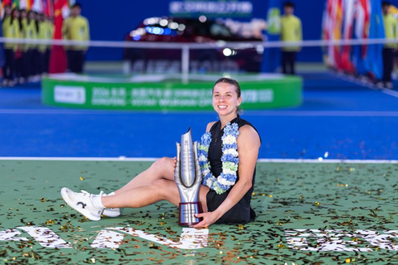 La polaca Maja Chwalinska celebra con el trofeo tras vencer a la británica Sonay Kartal en la final del Abierto de Wuhan el domingo 18 de octubre del 2026. (Chinatopix Via AP)