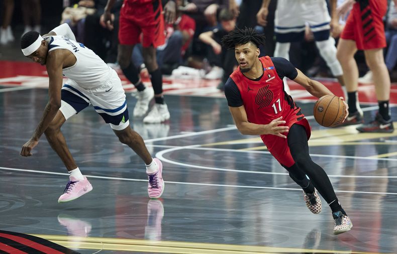 Shaedon Sharpe, base de los Trail Blazers de Portland, elude a Jaden McDaniels, de los Timberwolves de Minnesota, en el partido del martes 12 de noviembre de 2024 (AP Foto/Craig Mitchelldyer)
