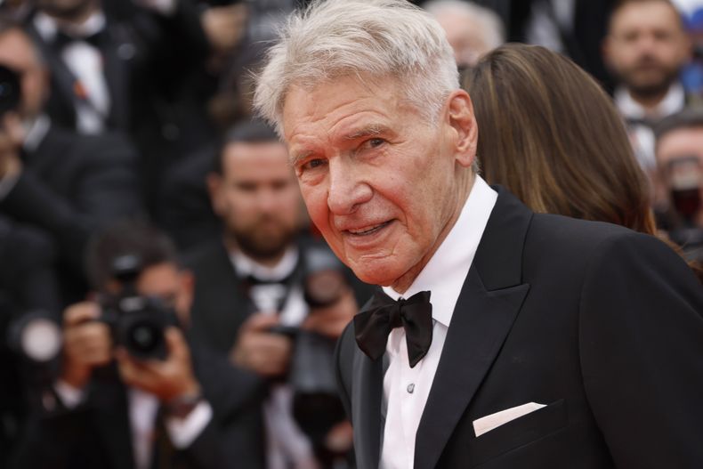 Harrison Ford posa a su llegada al estreno de la película Indiana Jones and the Dial of Destiny en la 76a edición del festival internacional de cine de Cannes, en sur de Francia, el jueves 18 de mayo de 2023. (Foto Vianney Le Caer/Invision/AP)