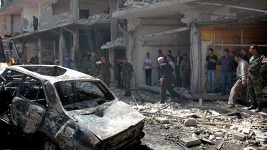 americateve | Fotograf&iacute;a distribuida por la agencia oficial de noticias siria SANA muestra gente reunida en el sitio donde estall&oacute; uno de dos carros bomba en el distrito de Zahra, en la ciudad de Homs, Siria, el martes 29 de abril de 2014. (Foto AP/SANA)