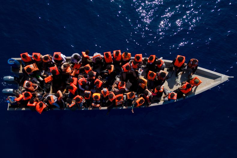 ARCHIVO - Migrantes de Eritrea, Libia y Sudán navegan en un bote de madera antes de ser asistidos por trabajadores humanitarios de la ONG española Open Arms, en el mar Mediterráneo, a unas 30 millas al norte de Libia, el sábado 17 de junio de 2023. (AP Foto/Joan Mateu Parra, archivo)