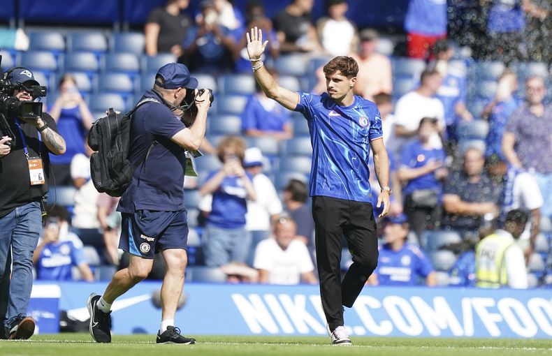 El portugués Pedro Neto, reciente contratación del Chelsea, saluda a los aficionados previo al partido de pretemporada del equipo en Stamford Bridge, en Londres, el domingo 11 de agosto de 2024. (Zac Goodwin/PA via AP)