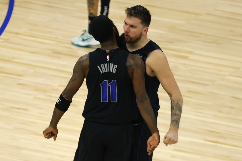 Kyrie Irving y Luka Doncic, de los Mavericks de Dallas, festejan una jugada en el segundo partido de la final de la Conferencia Oeste, ante los Timberwolves de Minnesota, el viernes 24 de mayo de 2204 (AP Foto/Bruce Kluckhohn)