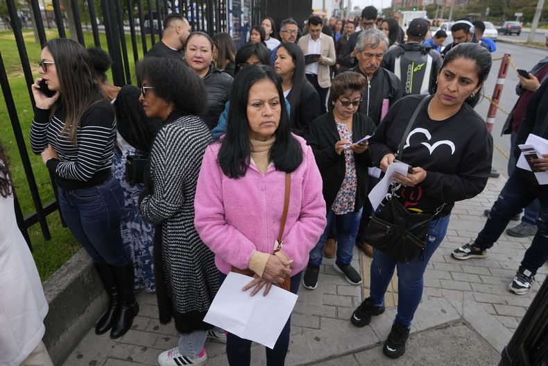 Gloria Camacho sostiene una notificación que indica que su cita para la visa fue cancelada debido a la negativa del presidente colombiano Gustavo Petro a aceptar vuelos de repatriación de ciudadanos colombianos desde Estados Unidos, afuera de la embajada de ese país en Bogotá, Colombia, el lunes 27 de enero de 2025. (AP Foto/Fernando Vergara)
